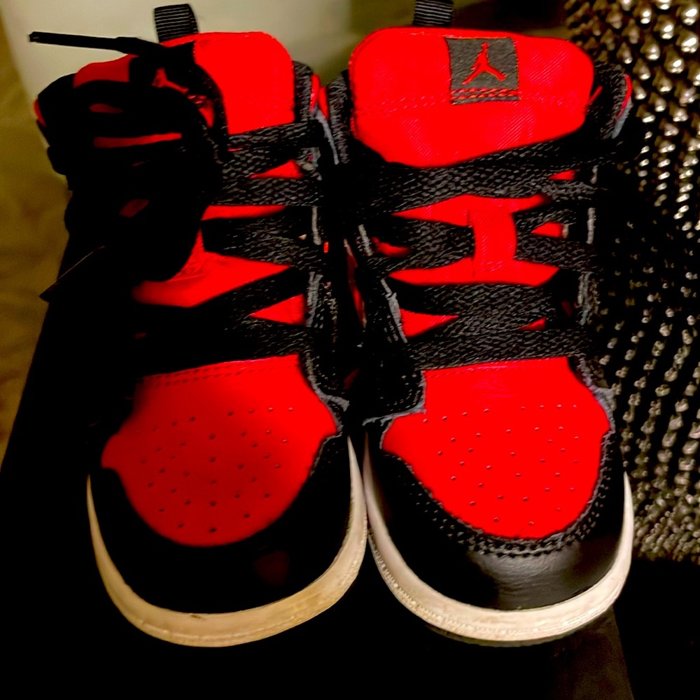 Red black and white high top Jordans.